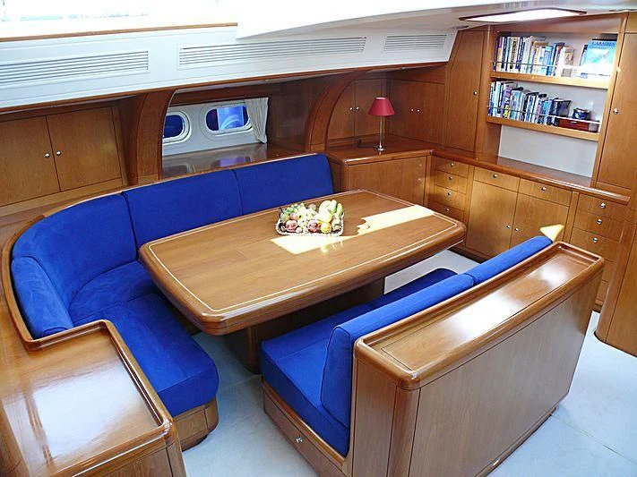 a living room with a blue couch aboard NAKUPENDA Yacht for Sale