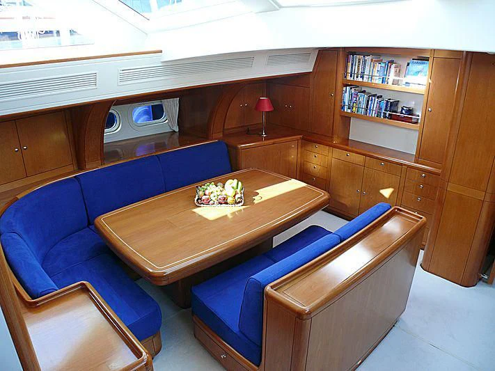 a room with a couch and a table aboard NAKUPENDA Yacht for Sale