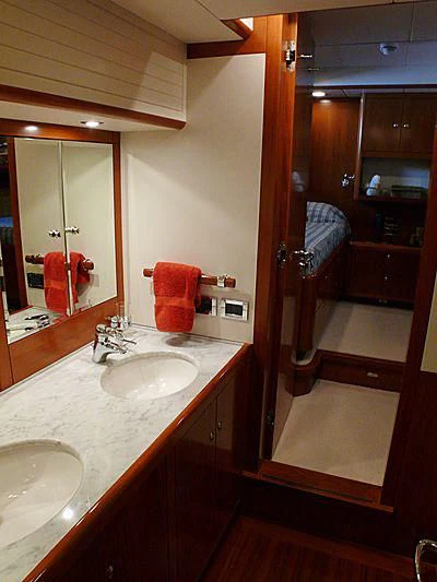 a bathroom with a sink and mirror aboard NAKUPENDA Yacht for Sale