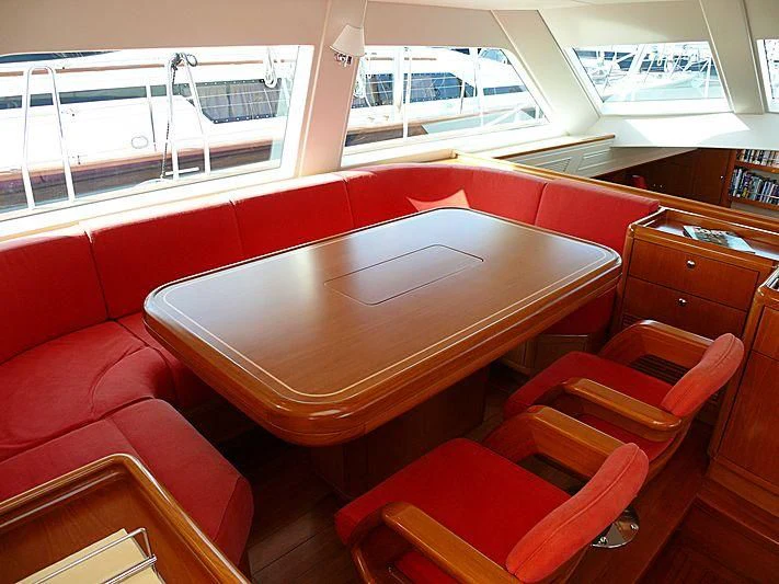 a table with chairs around it aboard NAKUPENDA Yacht for Sale