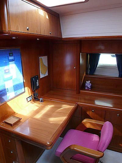 a room with a table and chairs aboard NAKUPENDA Yacht for Sale