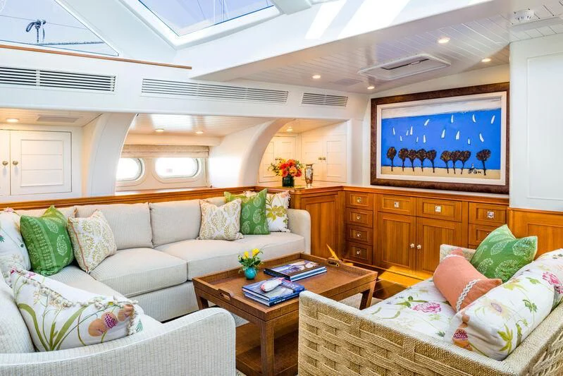 a living room with a couch and a coffee table aboard NAKUPENDA Yacht for Sale
