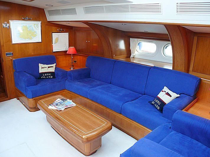a blue couch in a room aboard NAKUPENDA Yacht for Sale