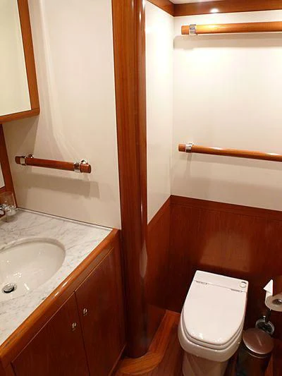 a bathroom with a toilet and sink aboard NAKUPENDA Yacht for Sale