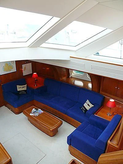 a room with a couch and a table aboard NAKUPENDA Yacht for Sale