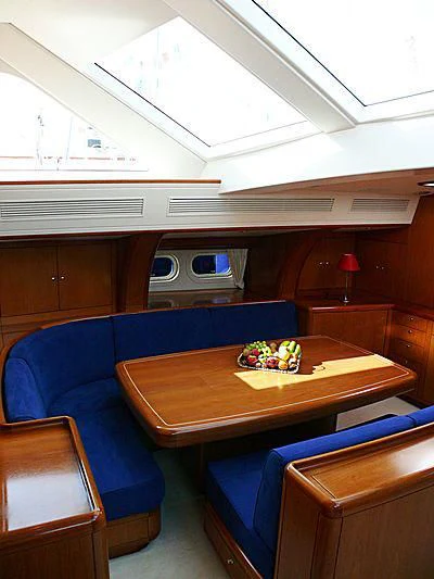 a room with a table and a tv aboard NAKUPENDA Yacht for Sale