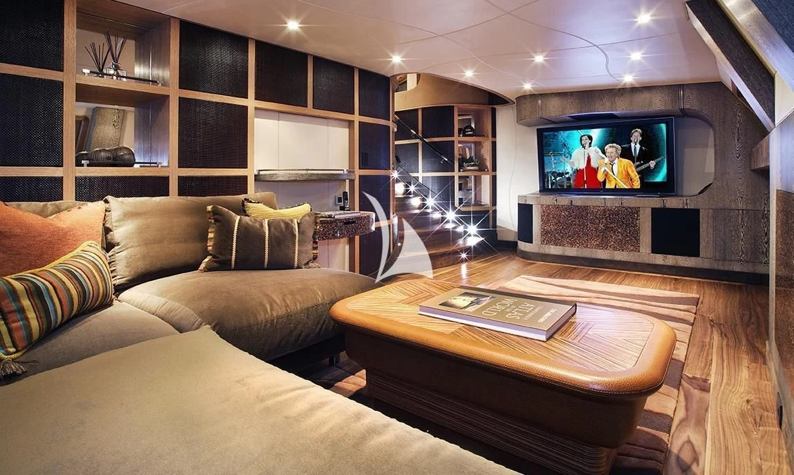 a living room with a tv and couches aboard HEMISPHERE Yacht for Sale