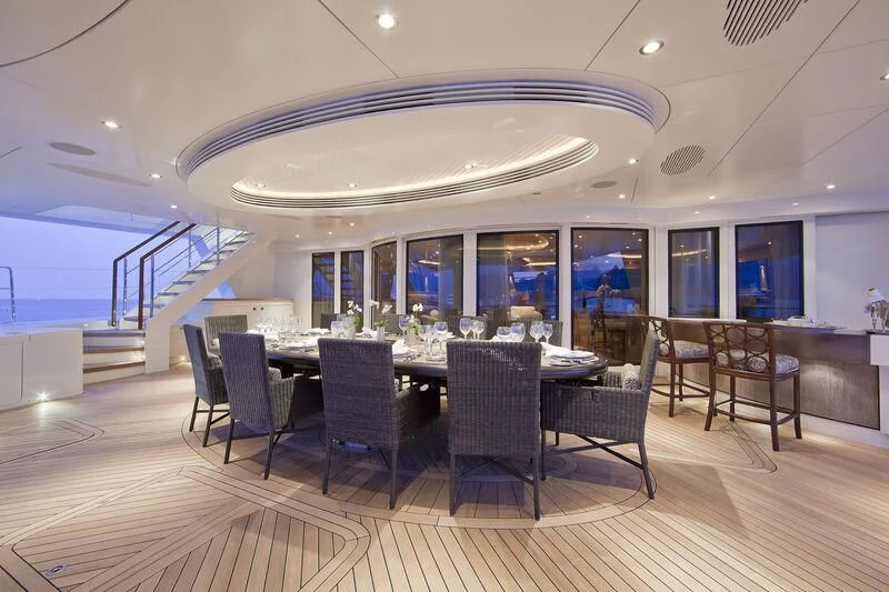 a large room with a table and chairs aboard HEMISPHERE Yacht for Sale