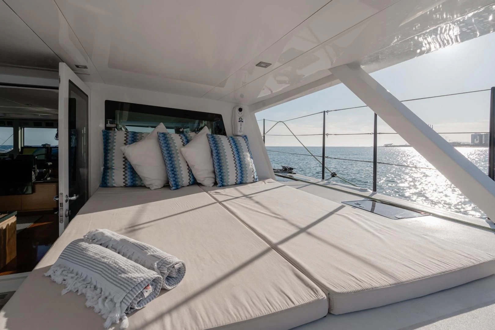 a bed with pillows on it aboard MY CAT Yacht for Sale