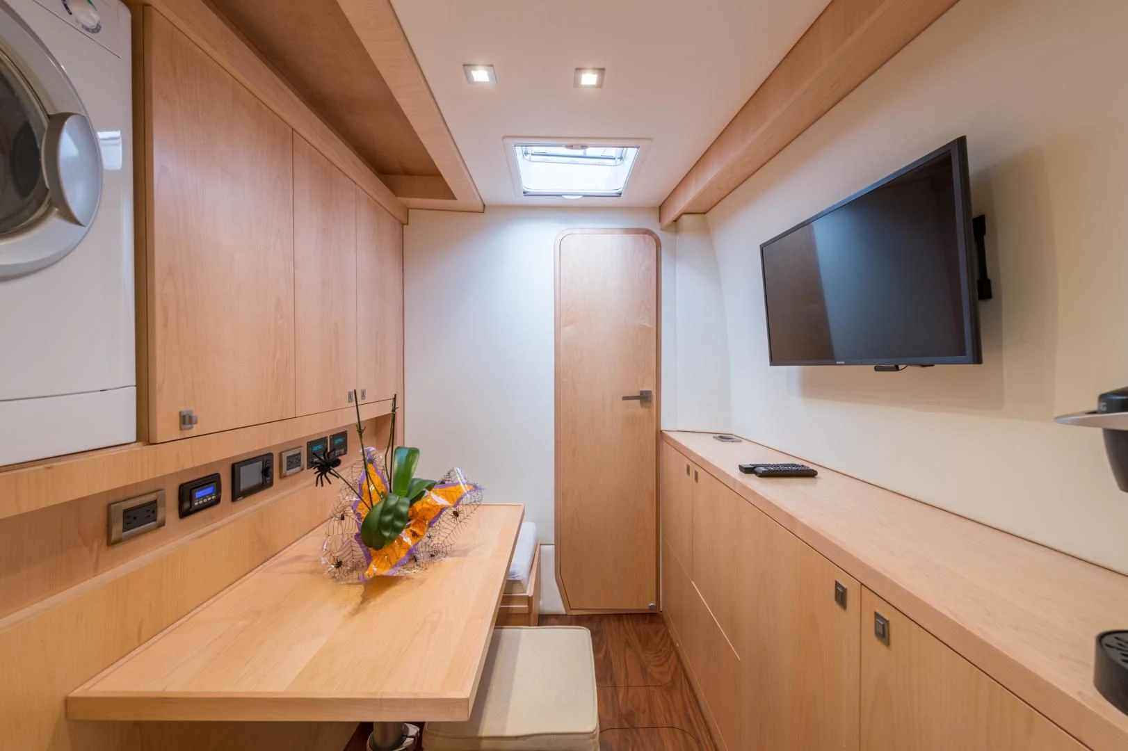 a kitchen with a tv and a table aboard MY CAT Yacht for Sale