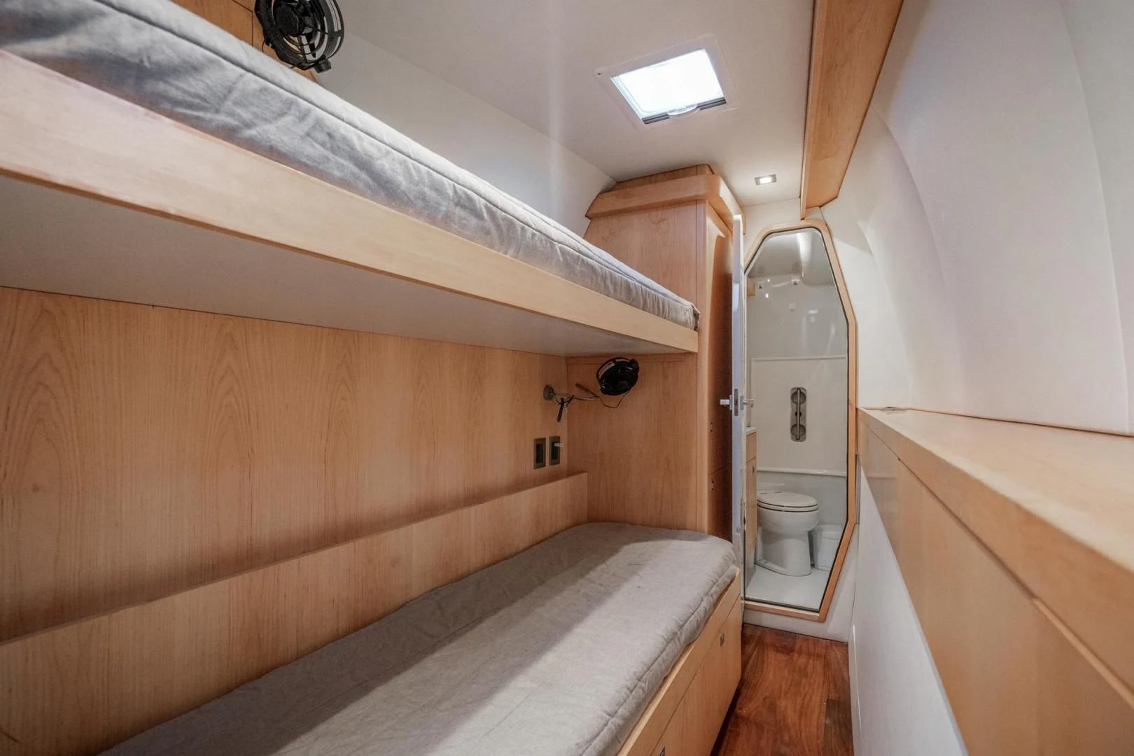 a bathroom with a toilet and a wooden cabinet aboard MY CAT Yacht for Sale