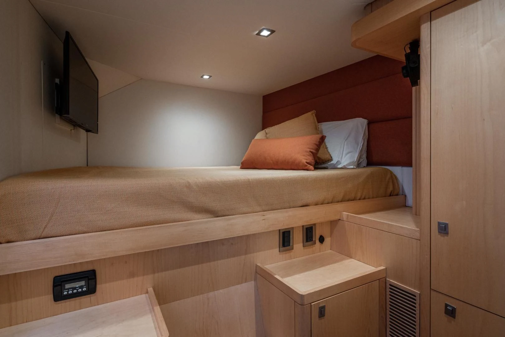 a bed with a tv on top aboard MY CAT Yacht for Sale