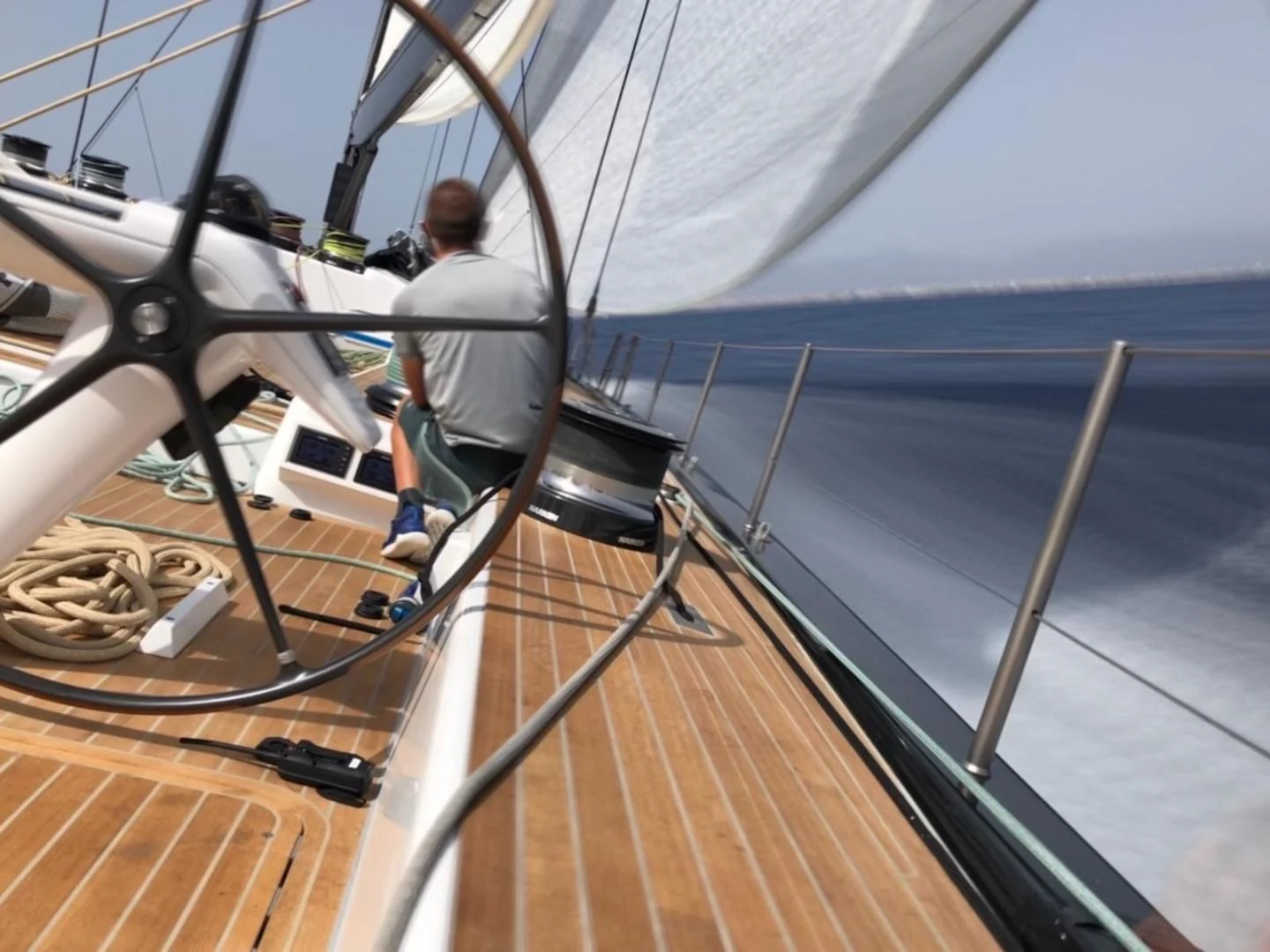 a person sitting on a deck of a boat aboard MY CAT Yacht for Sale