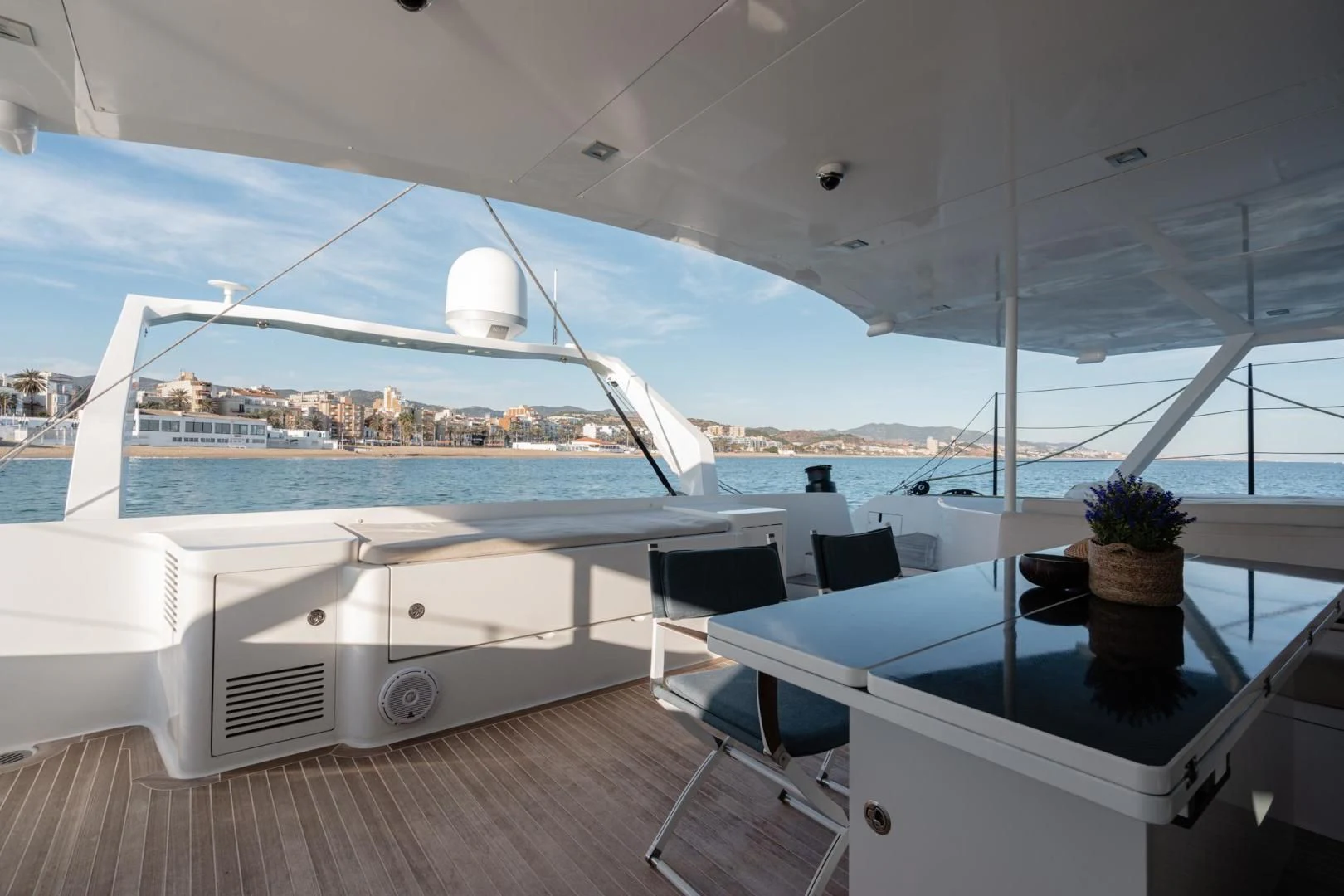 a large white yacht with a large white ship in the background aboard MY CAT Yacht for Sale