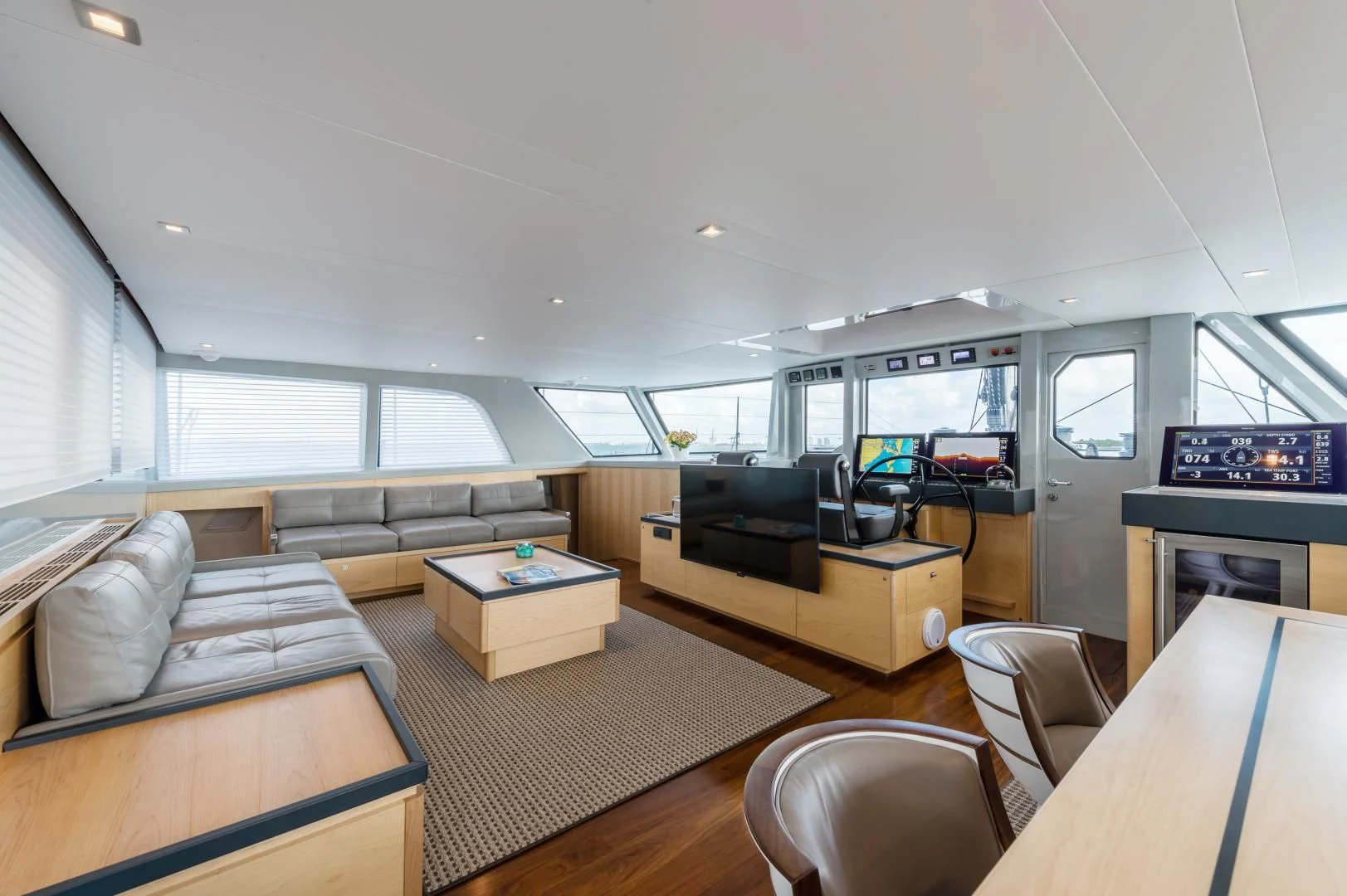 a living room with a large window aboard MY CAT Yacht for Sale