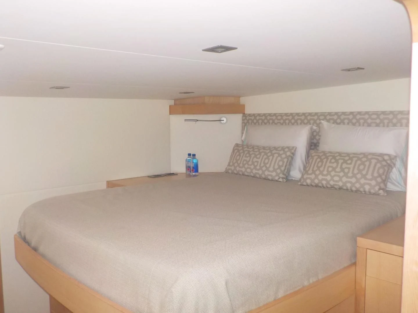 a bed with white sheets aboard MY CAT Yacht for Sale
