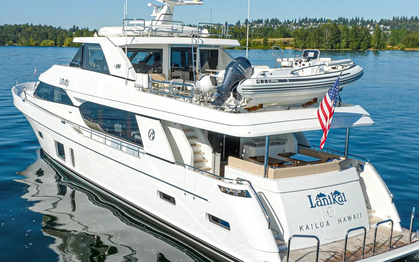 a boat with a flag on the front aboard HYAK Yacht for Sale