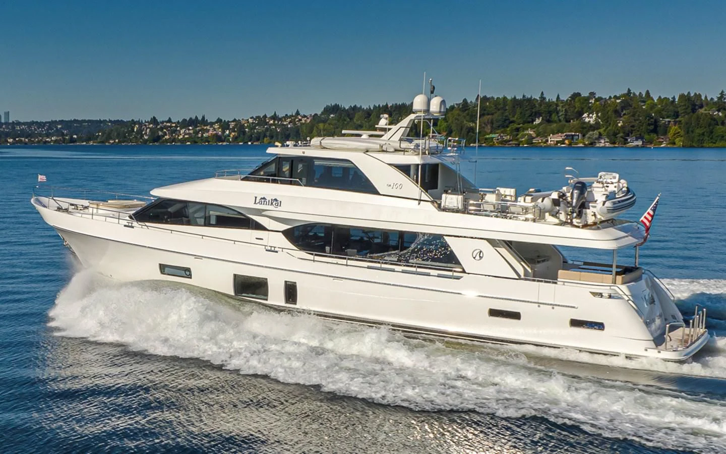 a white yacht on the water aboard HYAK Yacht for Sale