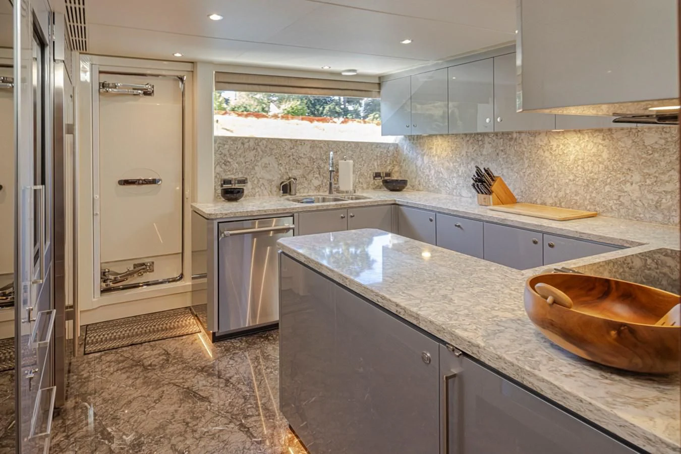 a kitchen with a large white refrigerator aboard HYAK Yacht for Sale