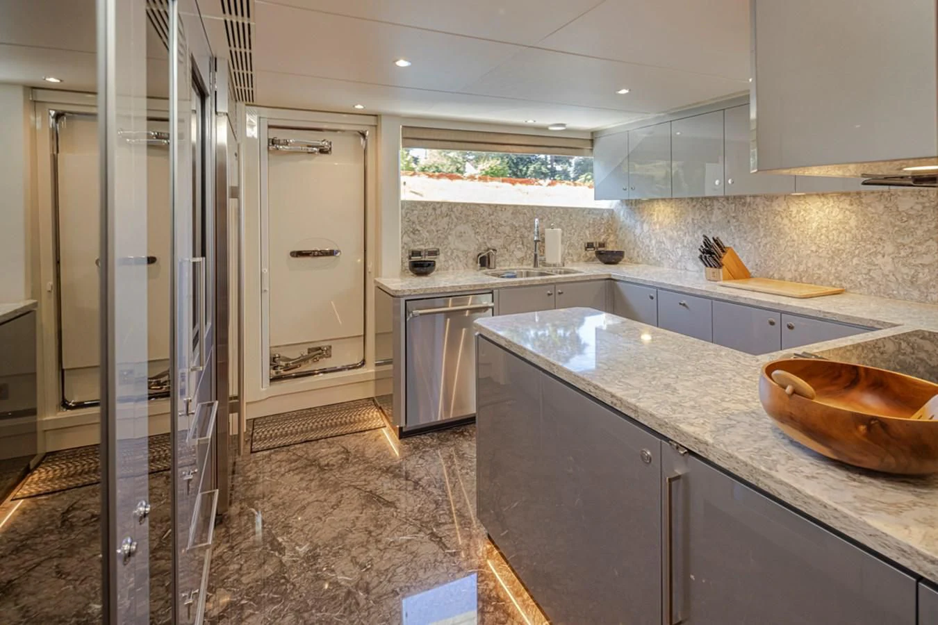 a kitchen with a large stainless steel refrigerator aboard HYAK Yacht for Sale