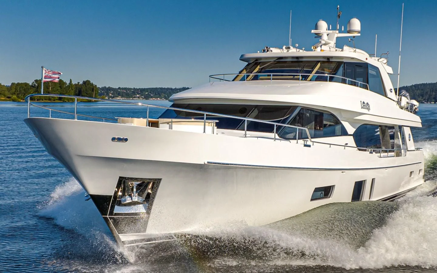 a white boat on a beach aboard HYAK Yacht for Sale