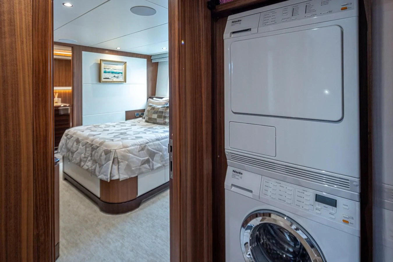 a bedroom with a washing machine aboard HYAK Yacht for Sale