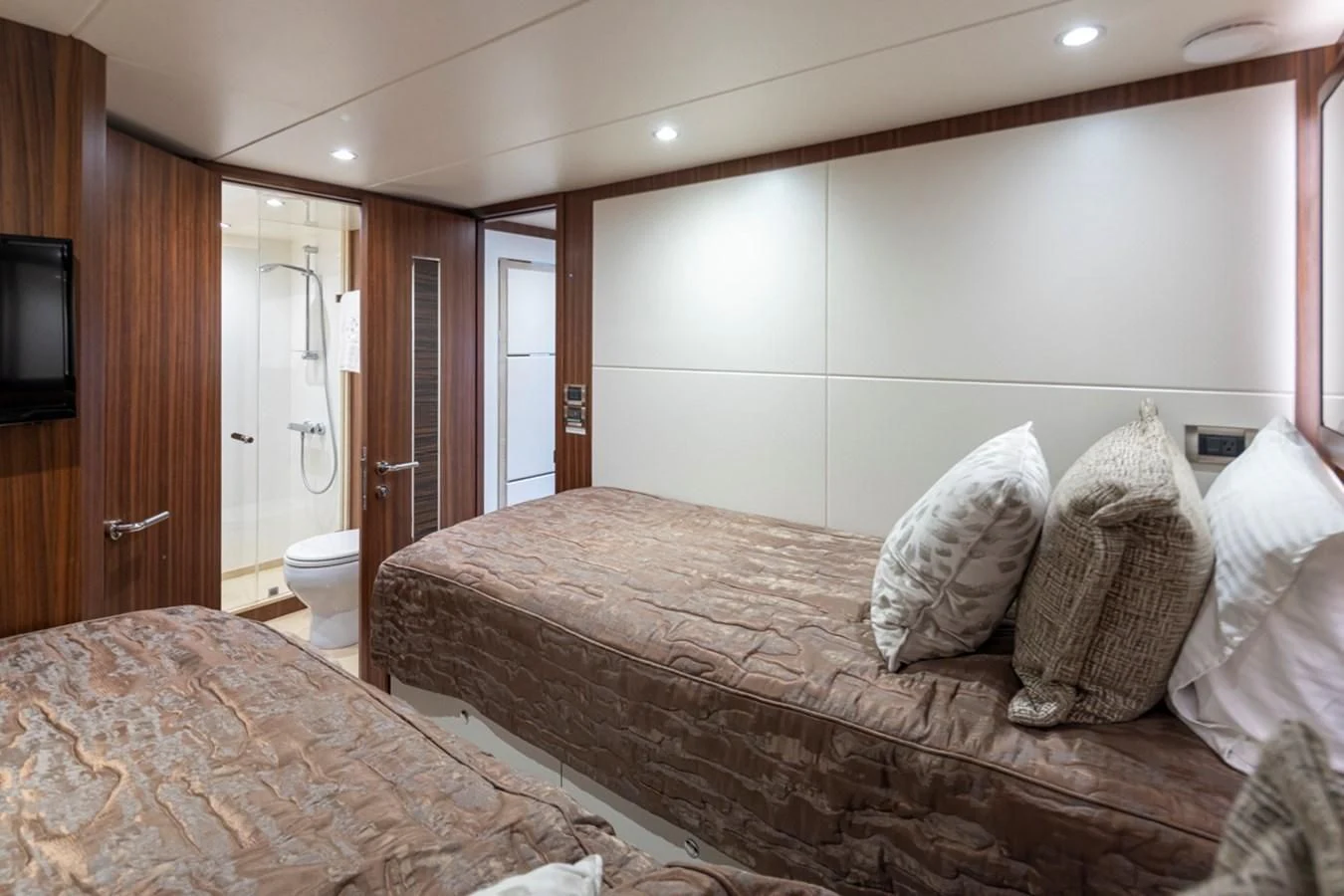 a bedroom with a bed and a television aboard HYAK Yacht for Sale