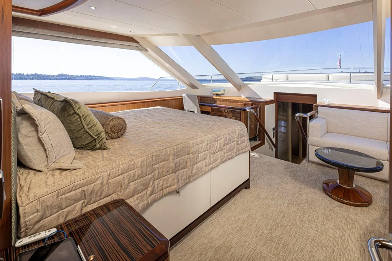 a bedroom with a bed and a chair aboard HYAK Yacht for Sale