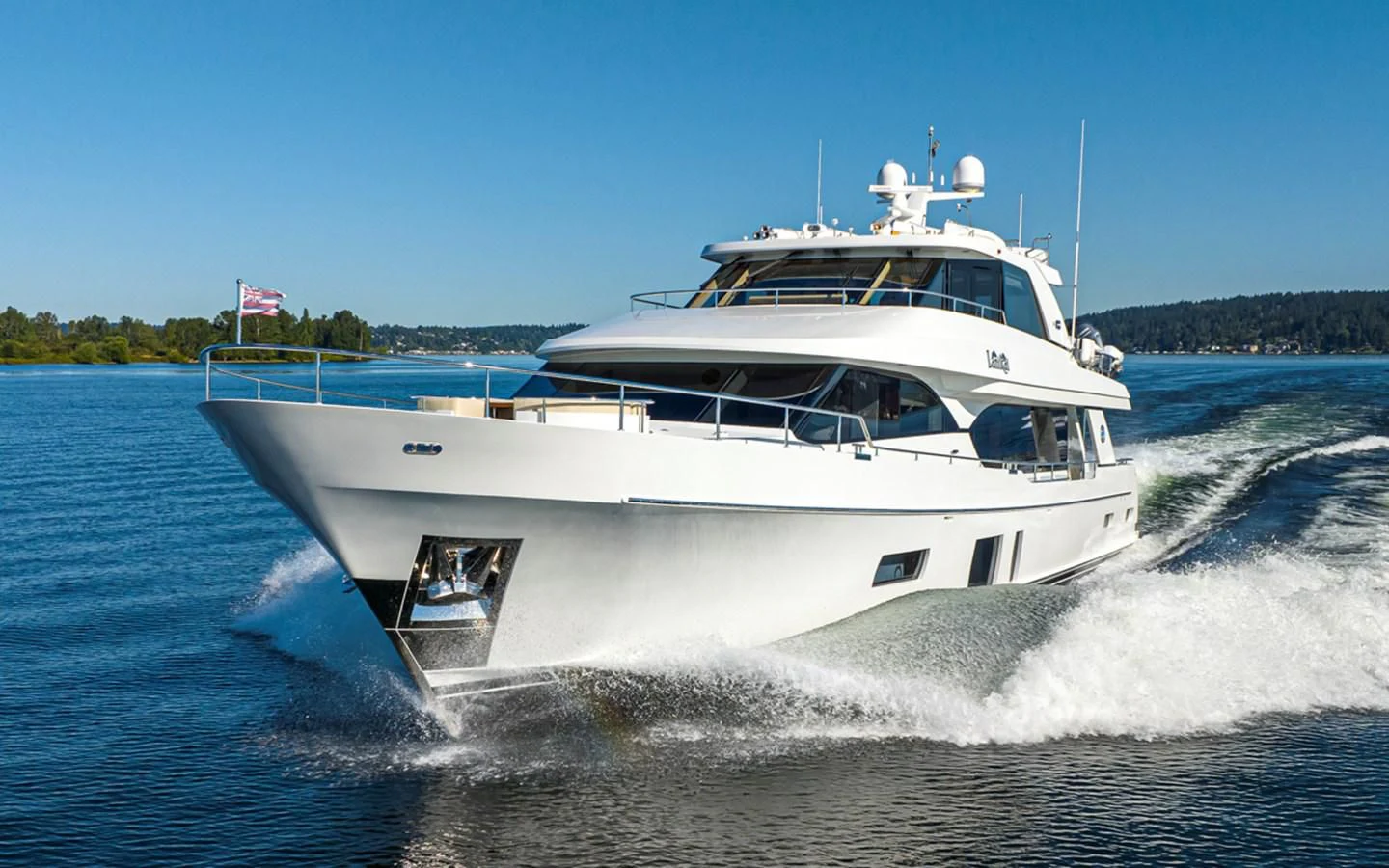 a white boat on the water aboard HYAK Yacht for Sale
