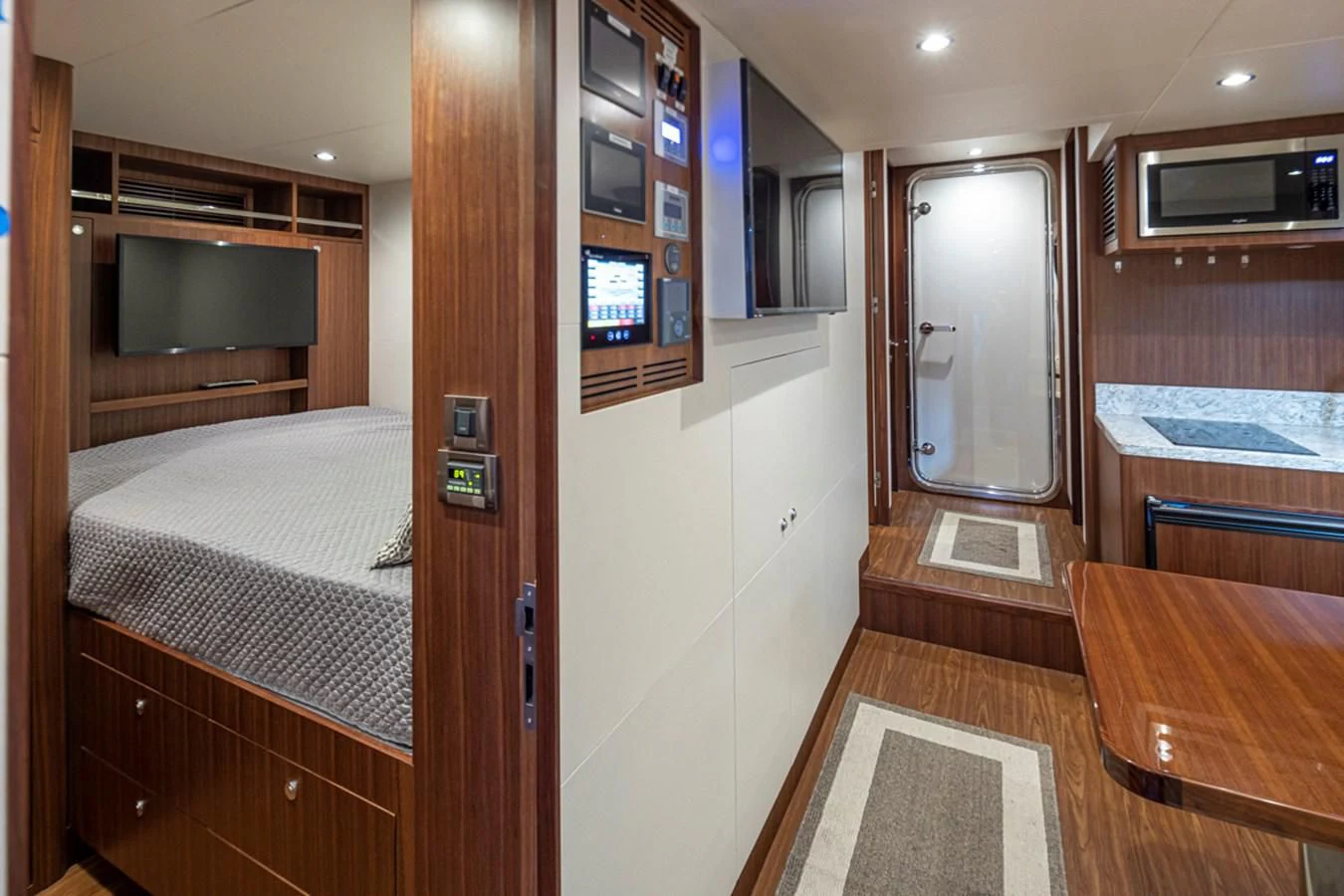 a room with a bed and a desk aboard HYAK Yacht for Sale