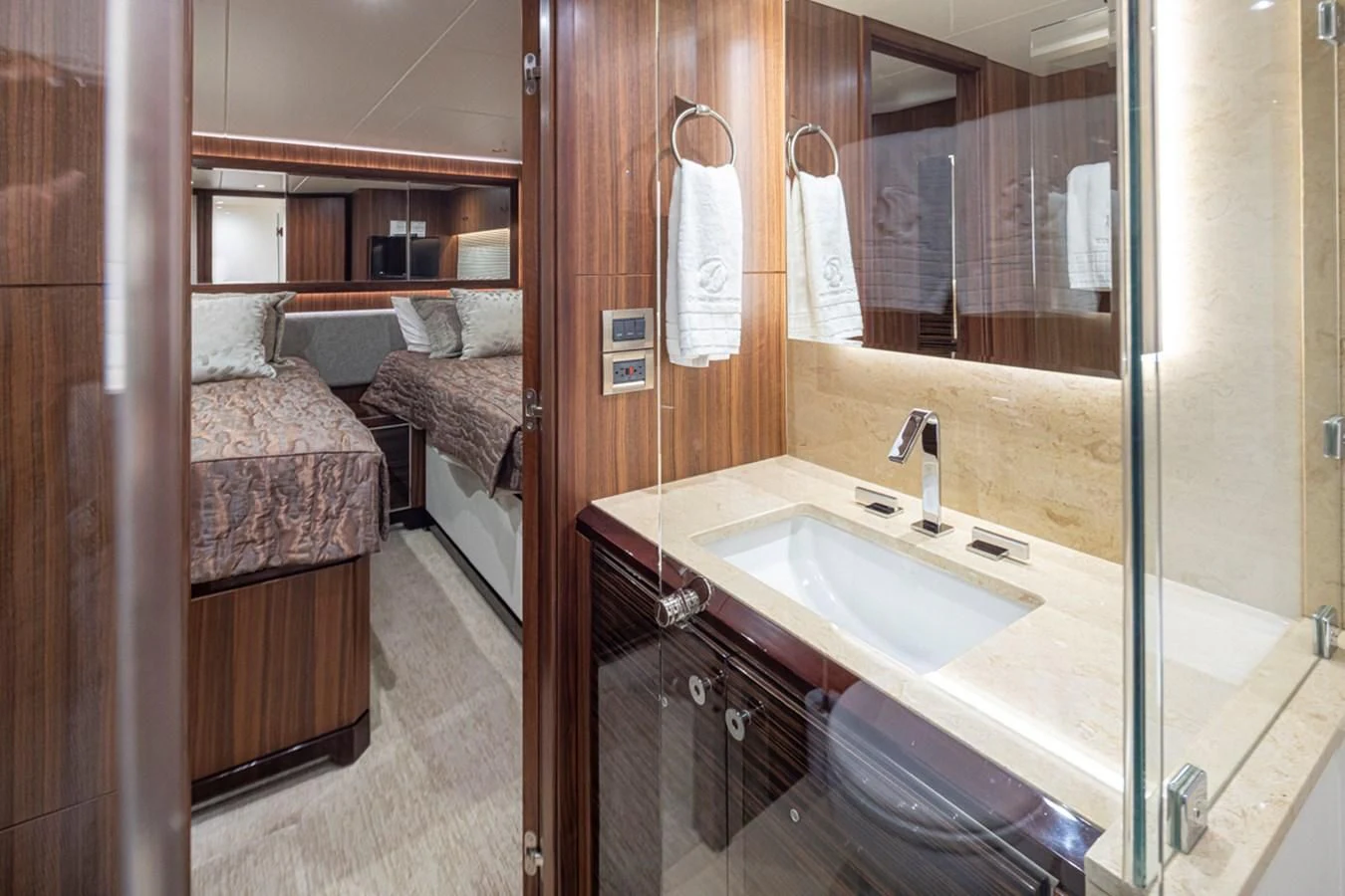 a bathroom with a sink and a bed aboard HYAK Yacht for Sale