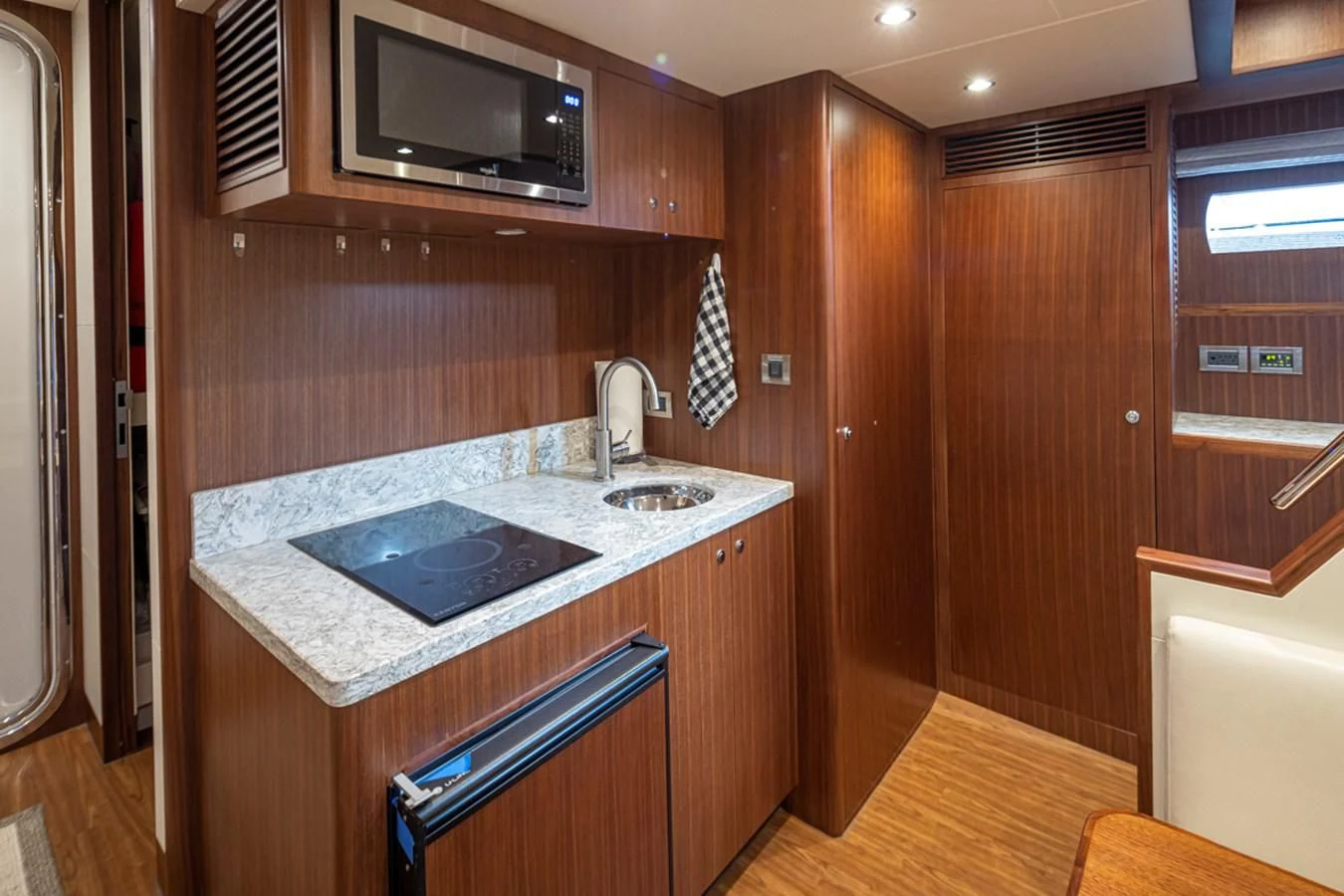 a kitchen with a sink and microwave aboard HYAK Yacht for Sale