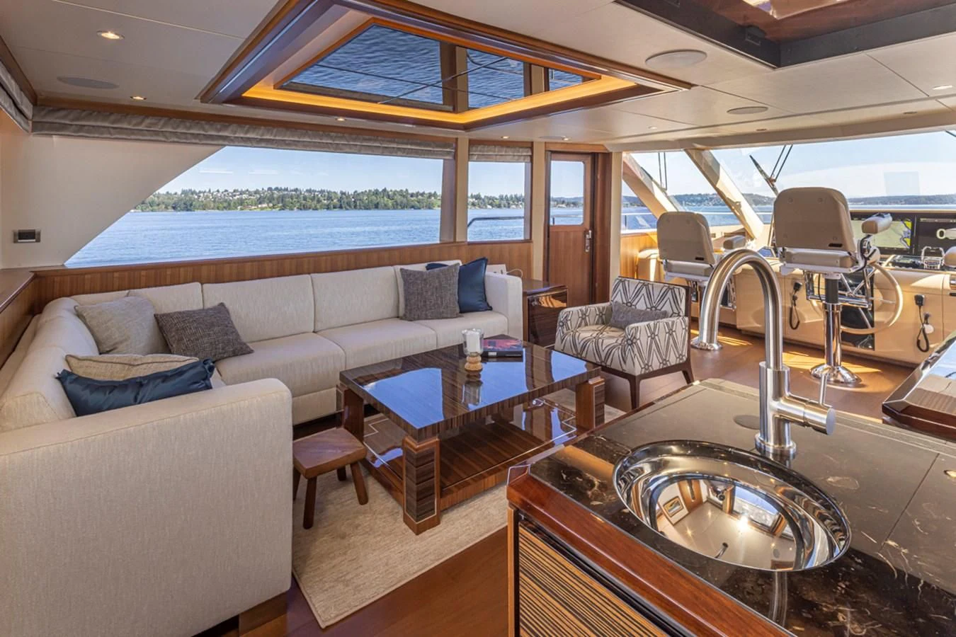a living room with a large table and chairs aboard HYAK Yacht for Sale