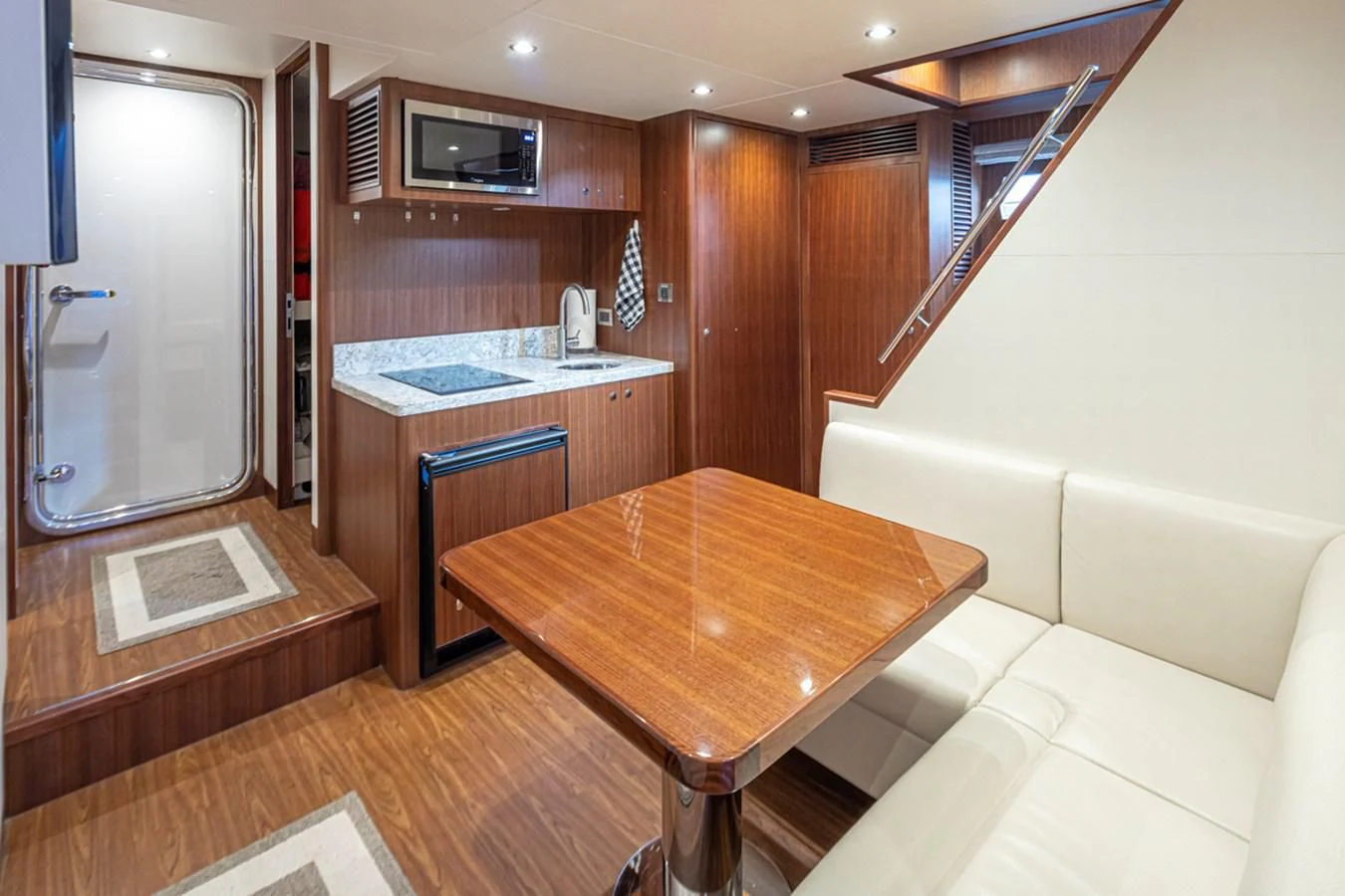a kitchen with a table and microwave aboard HYAK Yacht for Sale