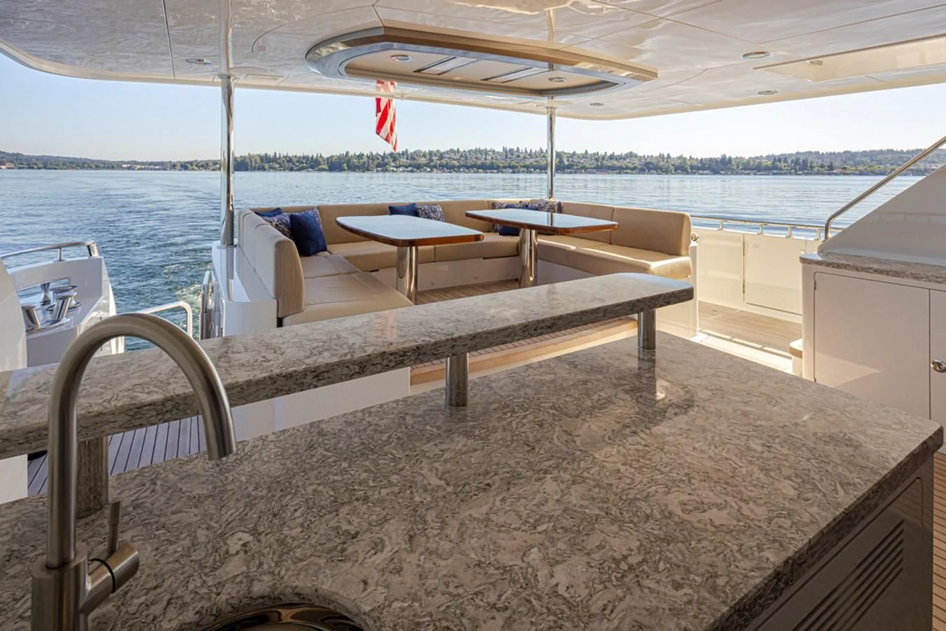 a table and chairs on a deck aboard HYAK Yacht for Sale