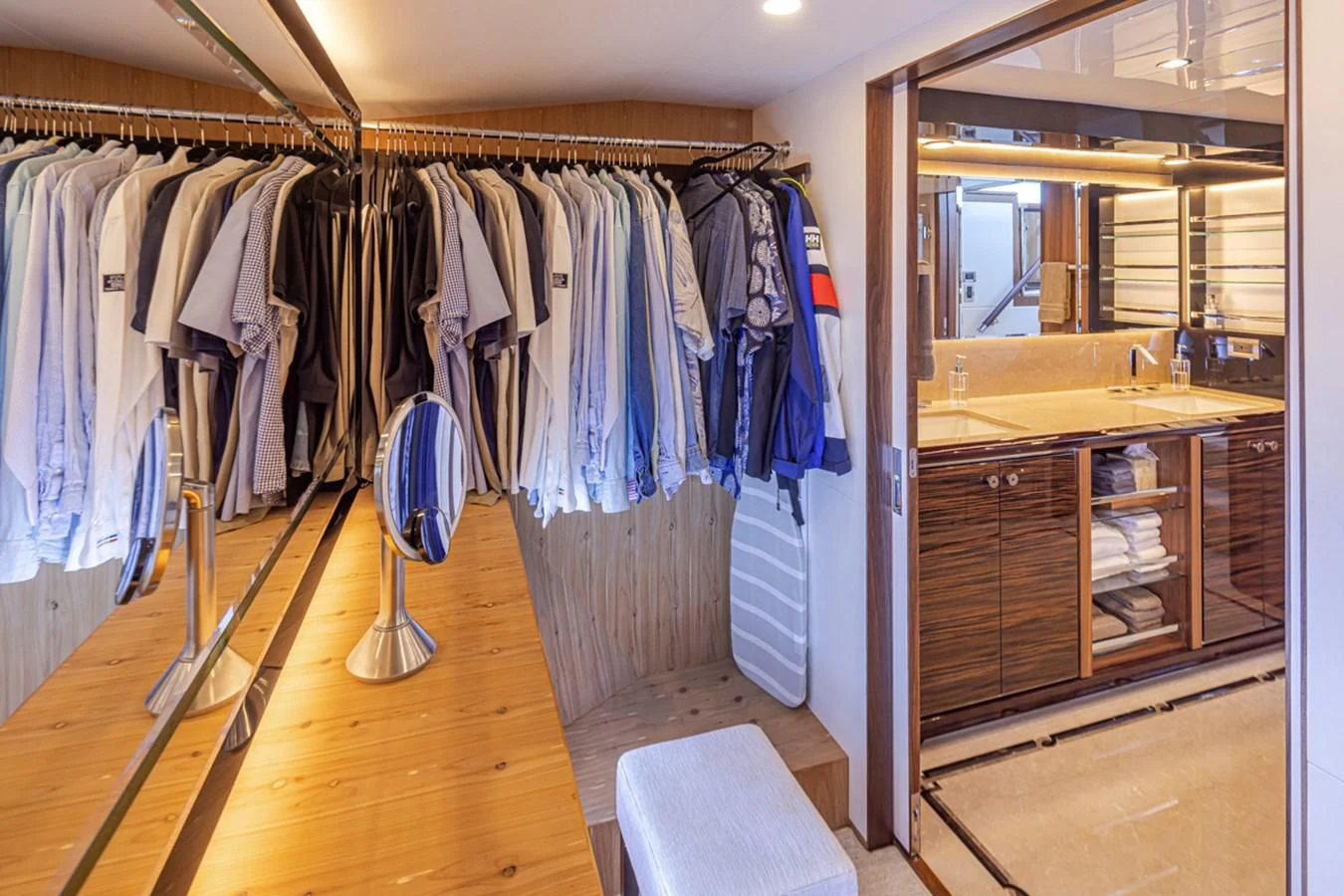 a closet with clothes on the wall aboard HYAK Yacht for Sale