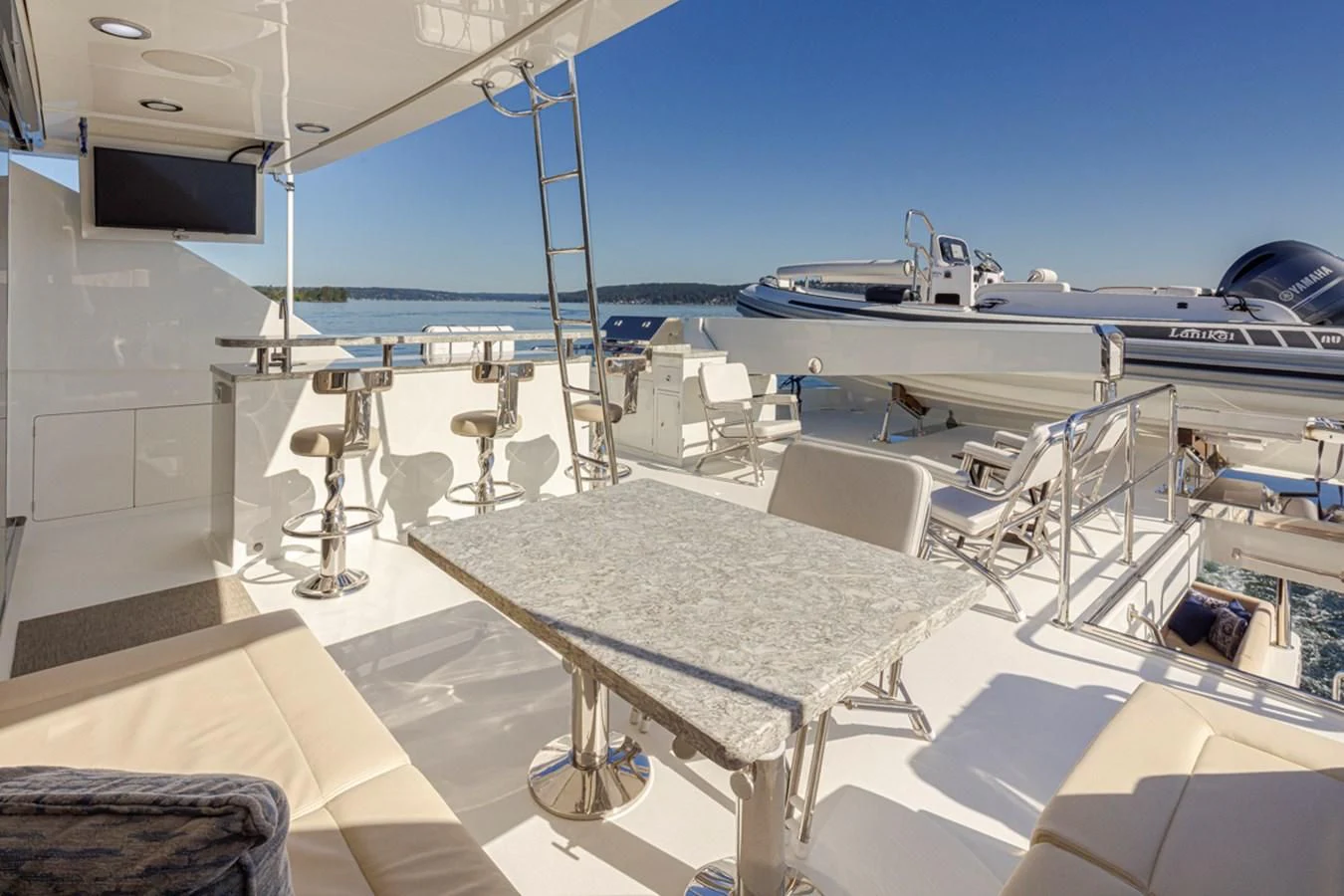 a room with a table and chairs aboard HYAK Yacht for Sale