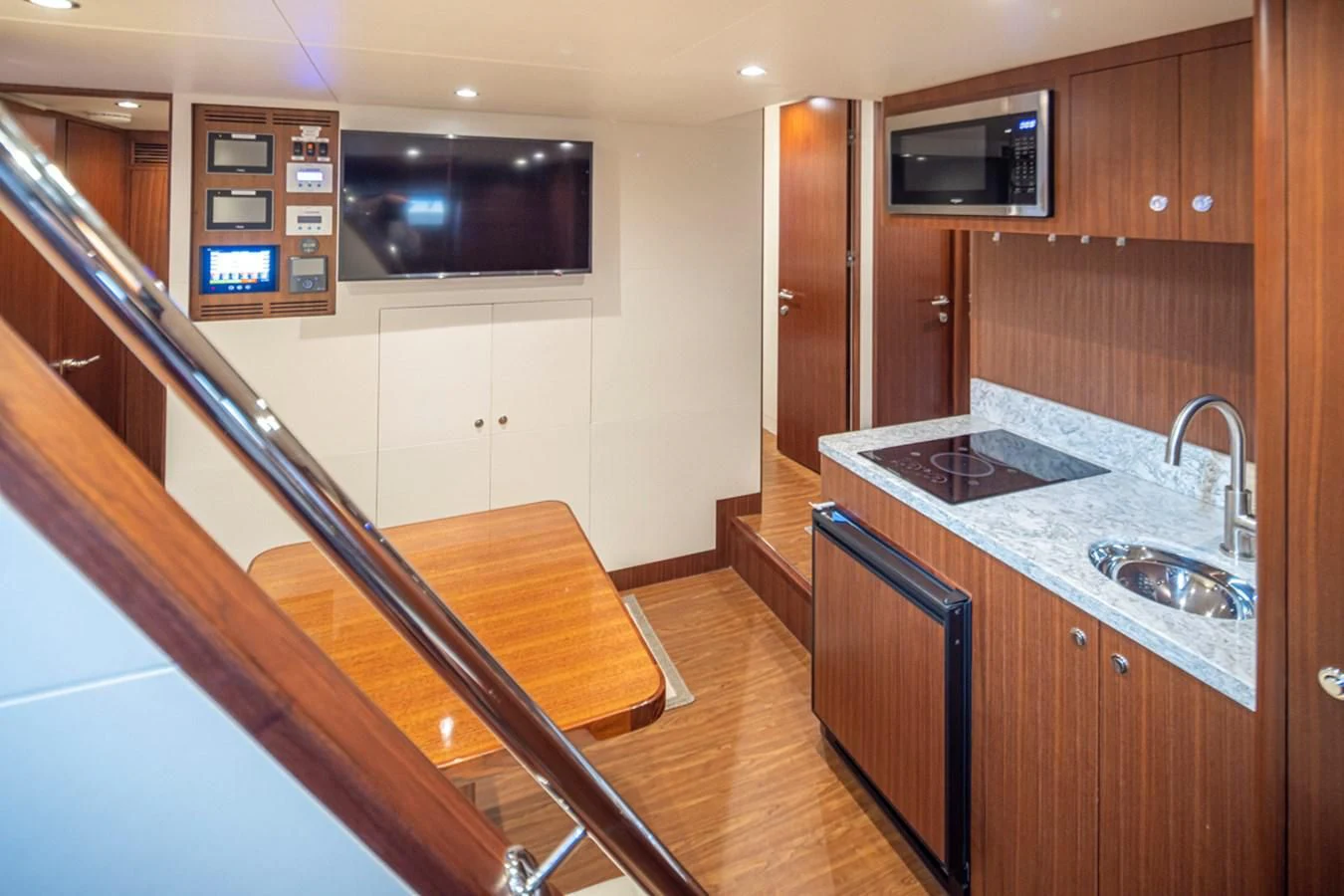 a kitchen with a wood floor aboard HYAK Yacht for Sale