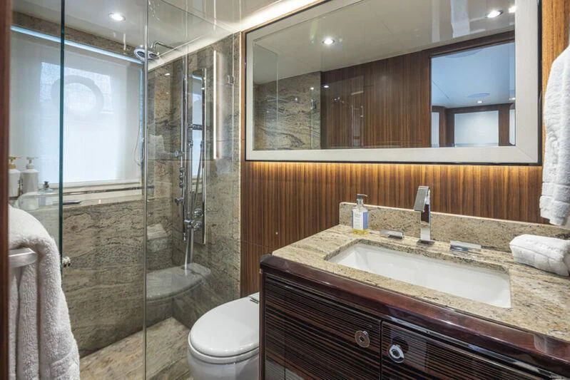 a bathroom with a glass shower aboard HYAK Yacht for Sale