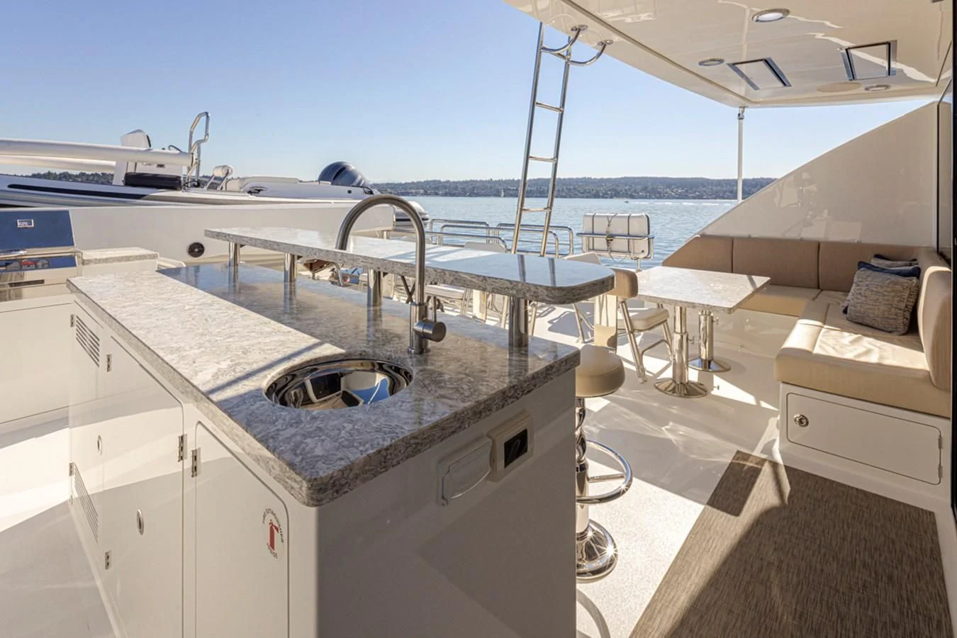 a large white kitchen with a view of the ocean aboard HYAK Yacht for Sale