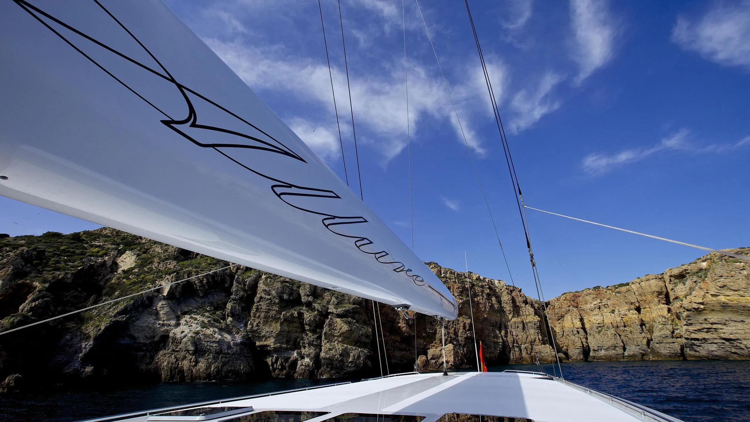 a long white boat on a body of water aboard ALLURE A Yacht for Sale