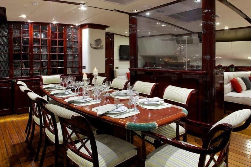 a dining room with a table set aboard ALLURE A Yacht for Sale