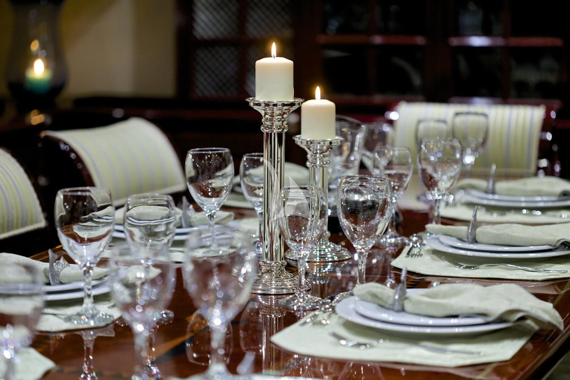 a table set with wine glasses and plates aboard ALLURE A Yacht for Sale