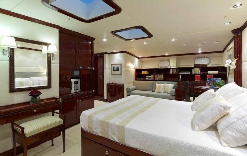 a large bedroom with a bed and a couch aboard ALLURE A Yacht for Sale