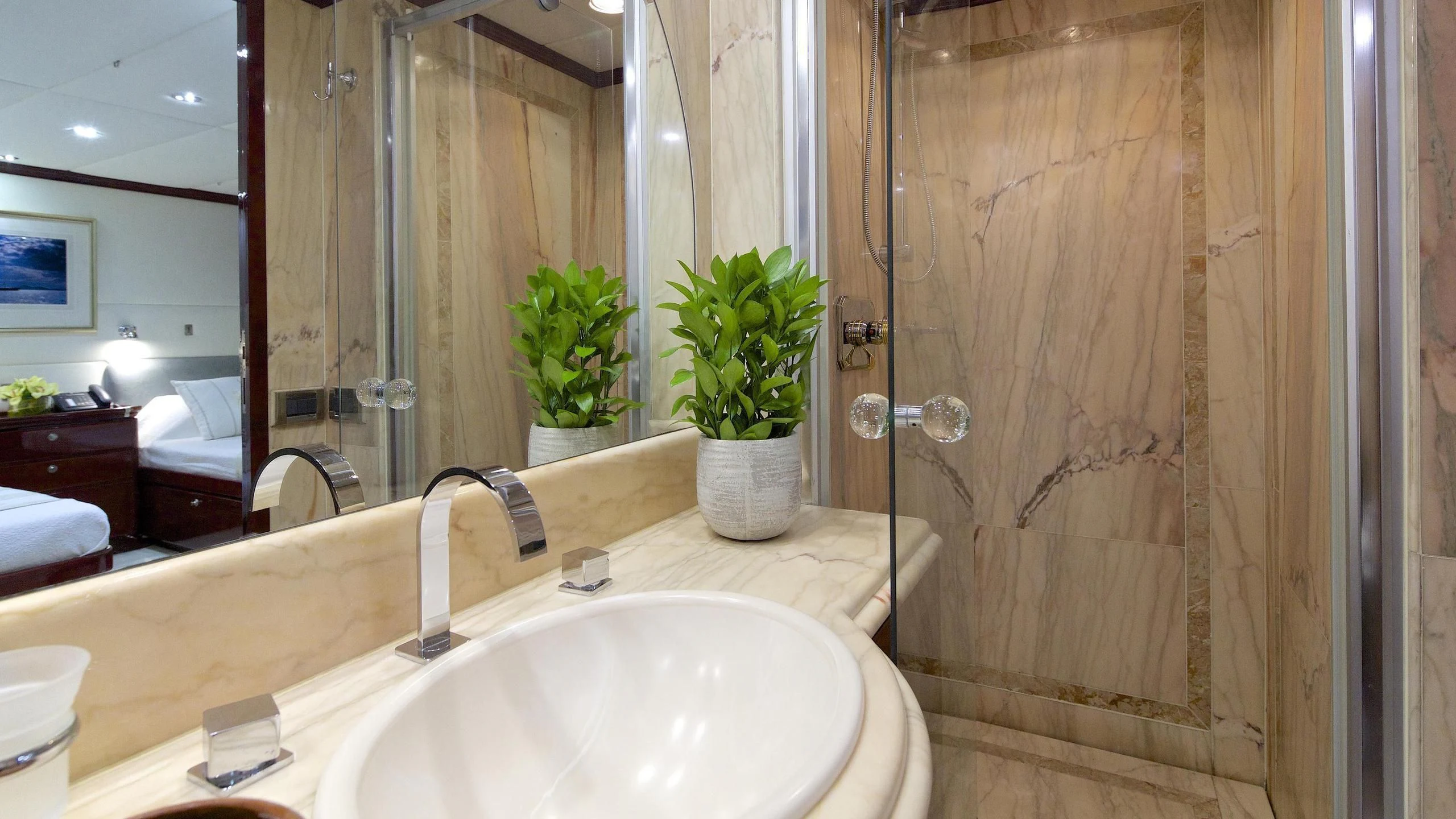 a bathroom with a sink and a plant in a pot aboard ALLURE A Yacht for Sale