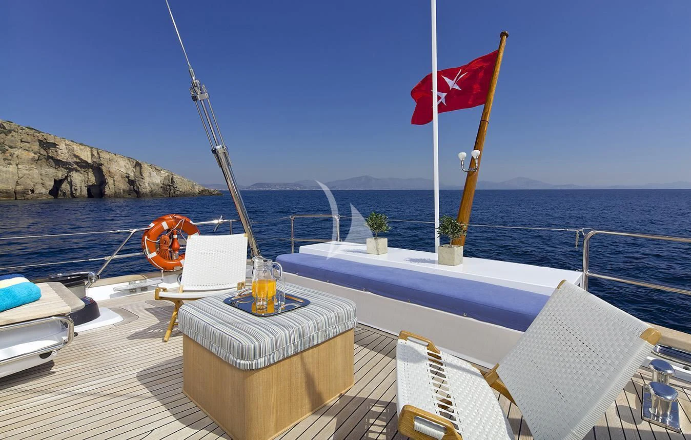 a boat on a deck with a flag on it aboard ALLURE A Yacht for Sale