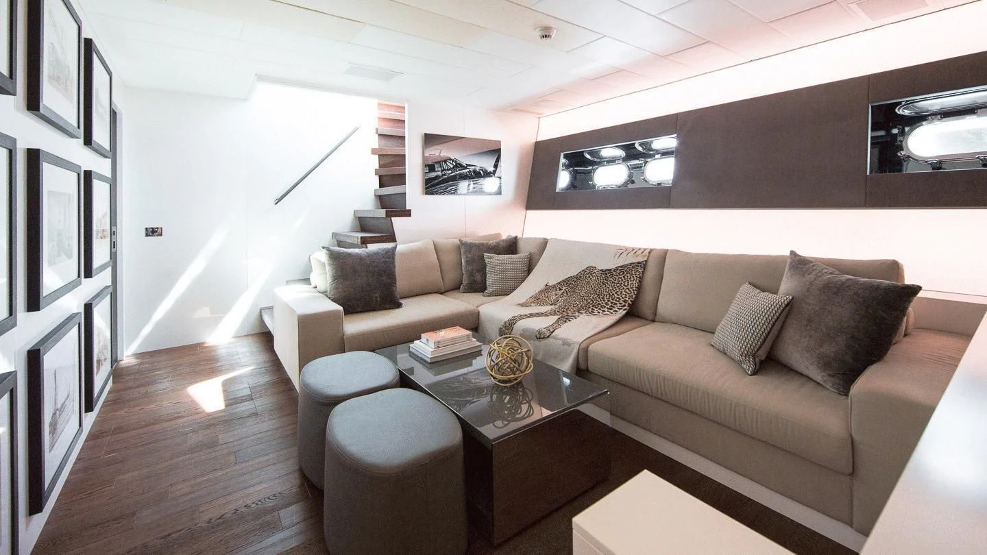 a living room with a couch and coffee table aboard ALLURE A Yacht for Sale
