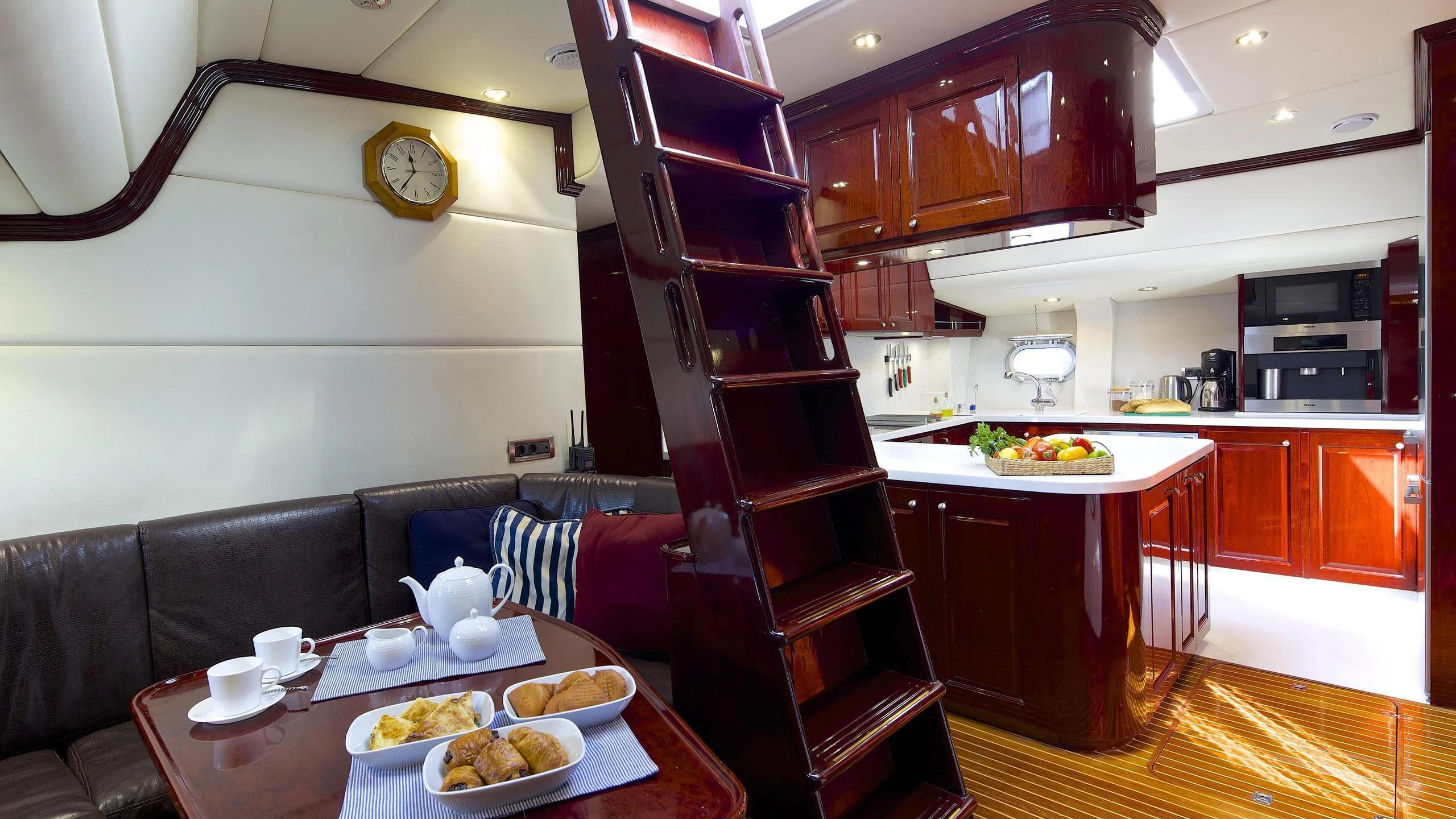 a kitchen with a table and a couch aboard ALLURE A Yacht for Sale