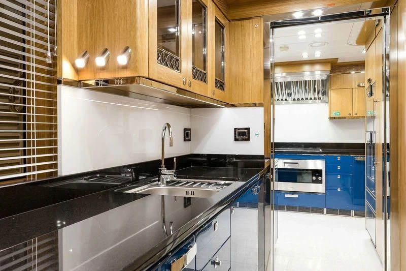 a kitchen with a stove and cabinets aboard VIATORIS Yacht for Sale