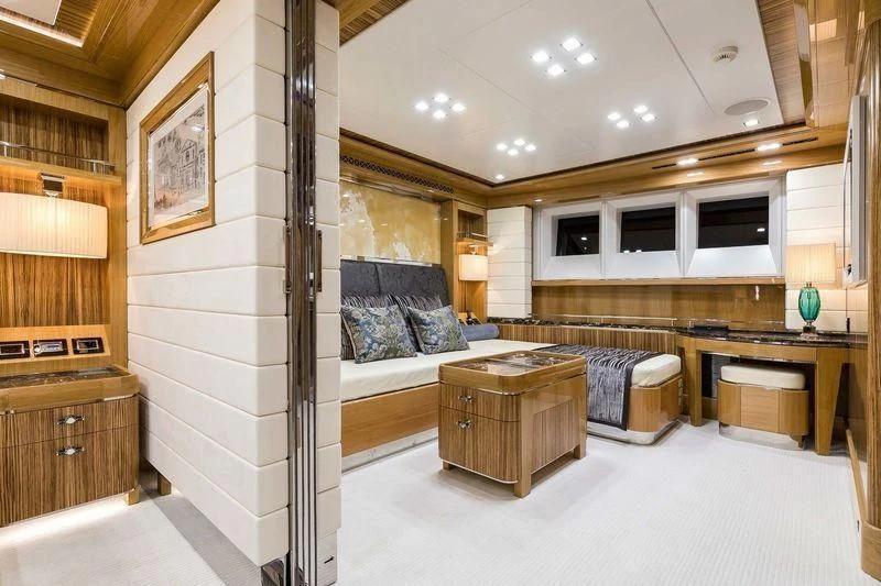 a room with a bed and a desk aboard VIATORIS Yacht for Sale